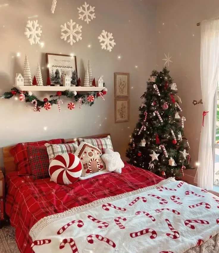 Bedroom with traditional red plaid tree, wooden furniture, and warm festive lighting.