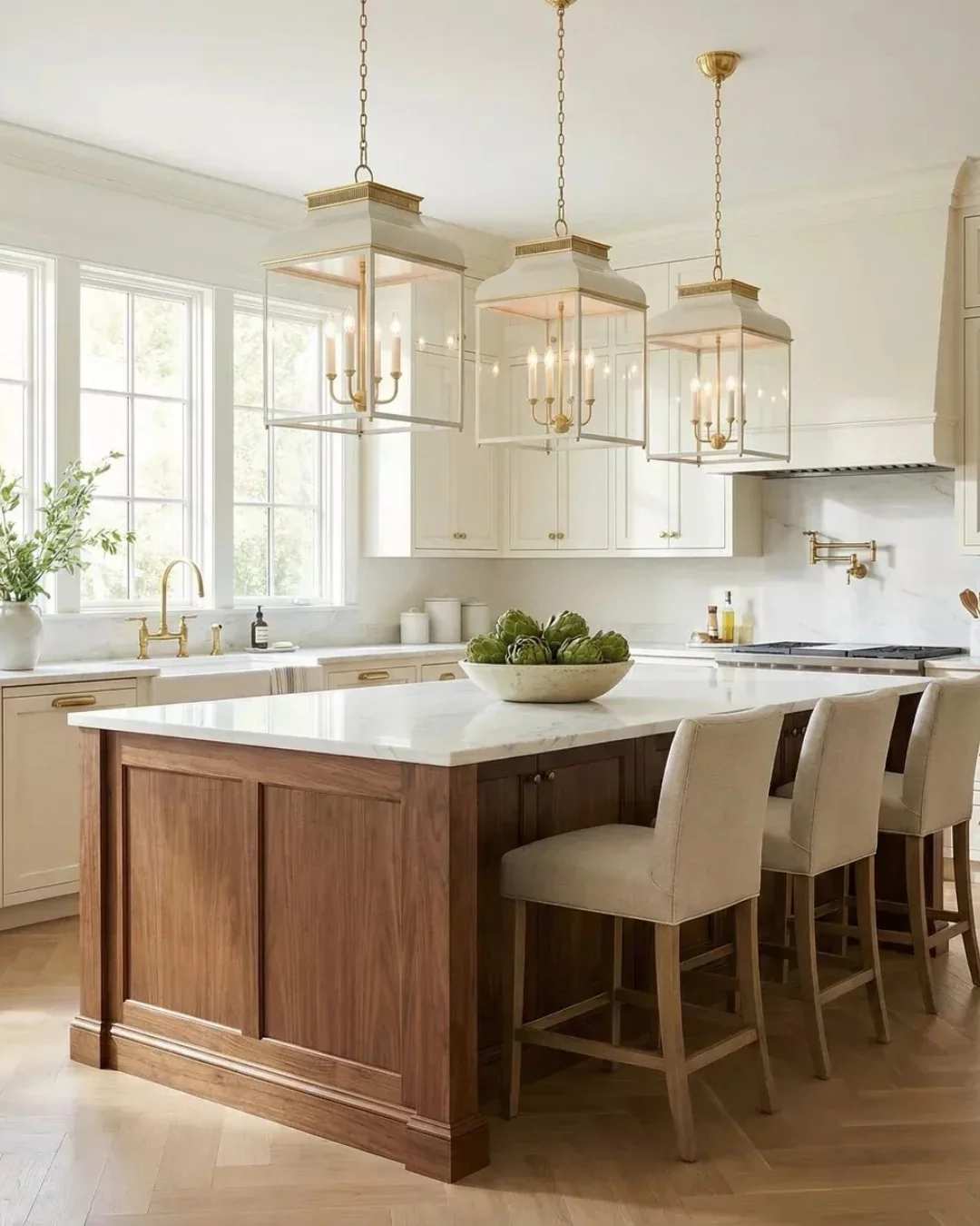 Transitional kitchen with white shaker cabinets, light oak island, brushed gold faucet, matte black floor tiles.