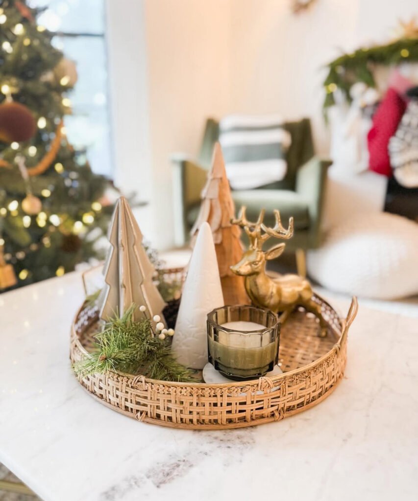 Elegant Christmas coffee table setup with golden deer figurines on a mirrored tray with tea lights.