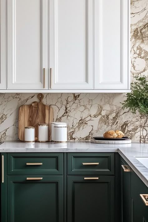 Dark green base cabinets, white upper cabinets, marble countertop, brushed gold hardware.