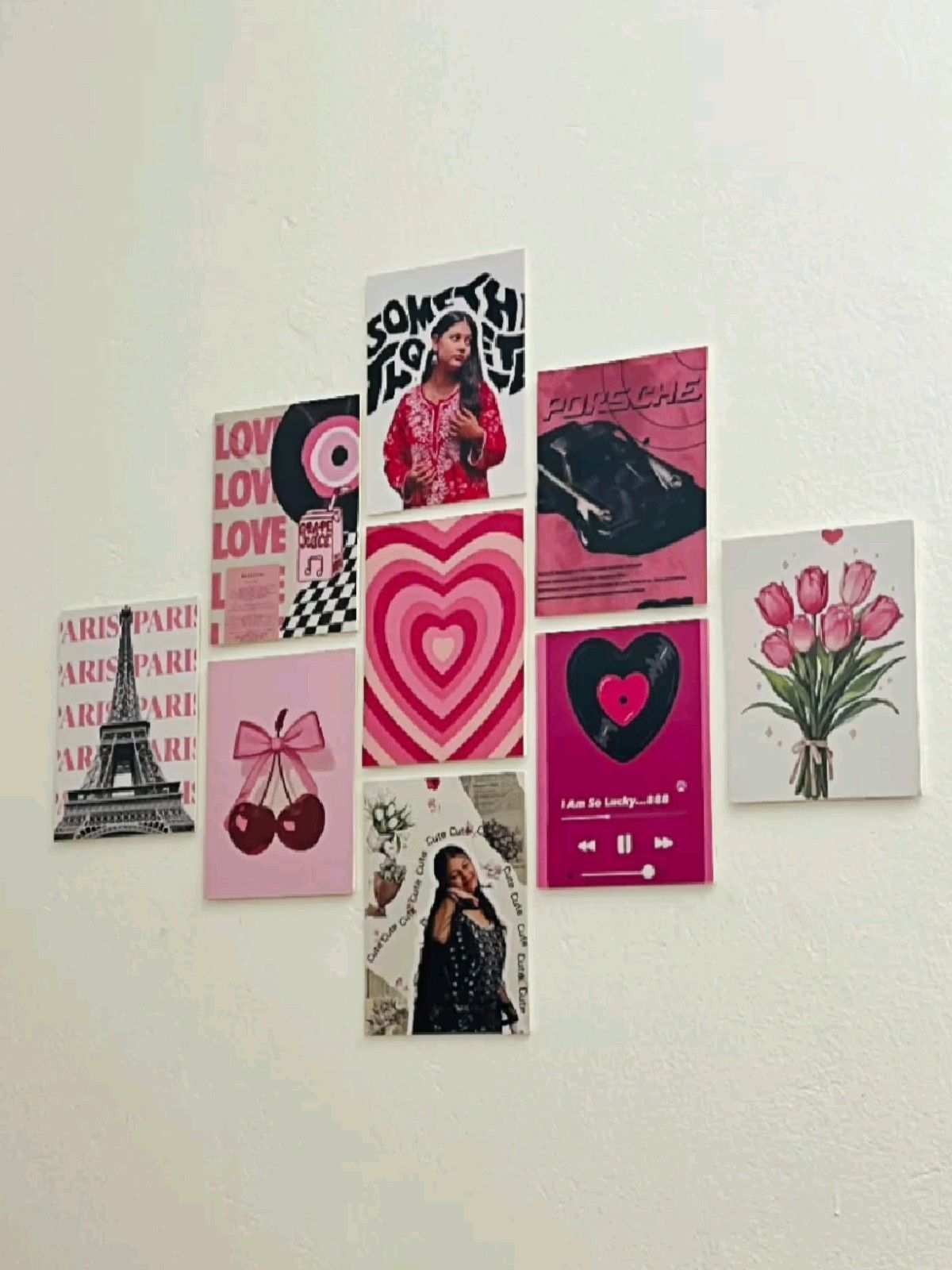 Wall of pink heart-themed posters and photos in a bright, youthful bedroom.