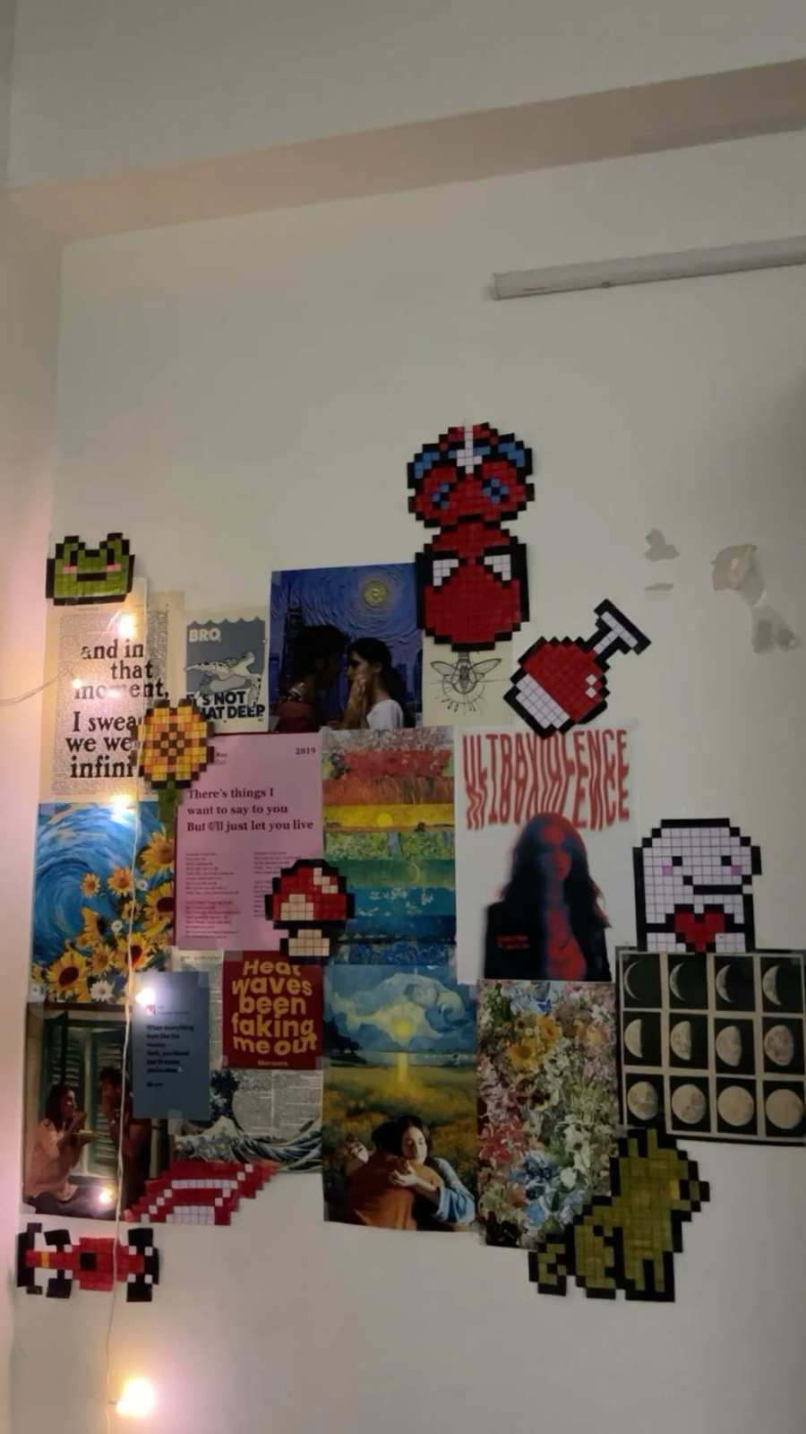 Wall of pixel art posters and photos in a colorful, retro-styled room.