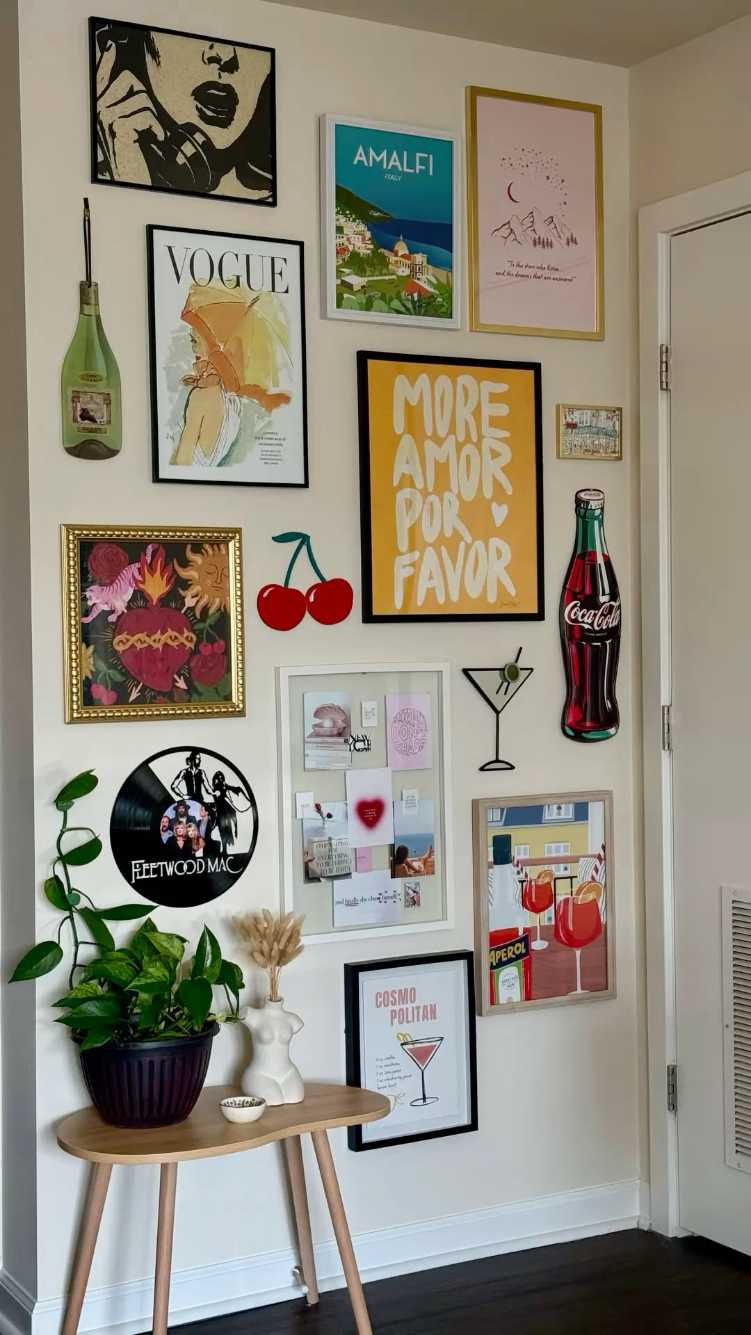 Wall of retro cocktail prints and a vinyl record in a stylish bar area.