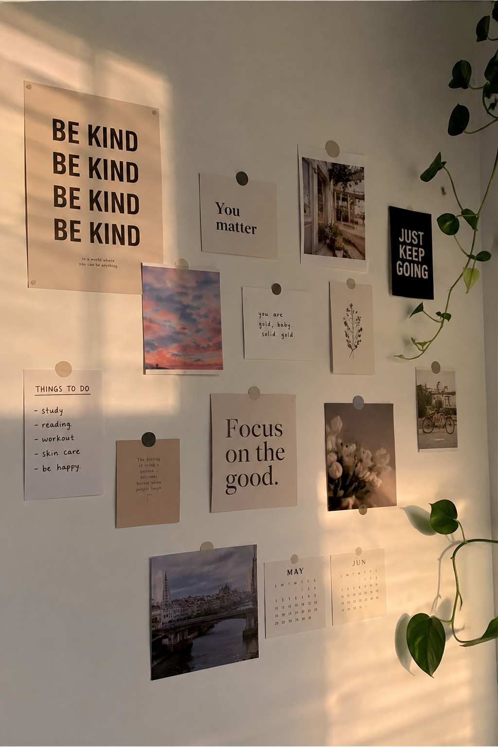 Wall of taped affirmation cards and trailing ivy in a bright home office.