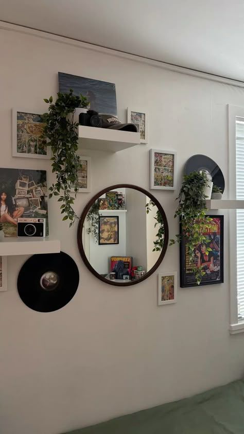 Wall of vinyl records and a round mirror in a stylish, music-themed room.
