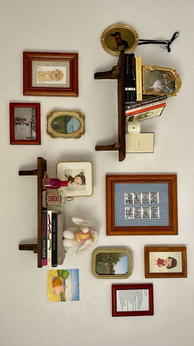 Light wooden shelves holding vintage frames and books in a cozy living room.