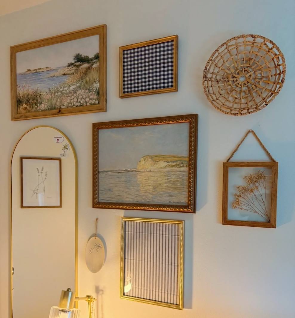 Woven basket and seascape frames on a wall in a coastal, breezy living room.