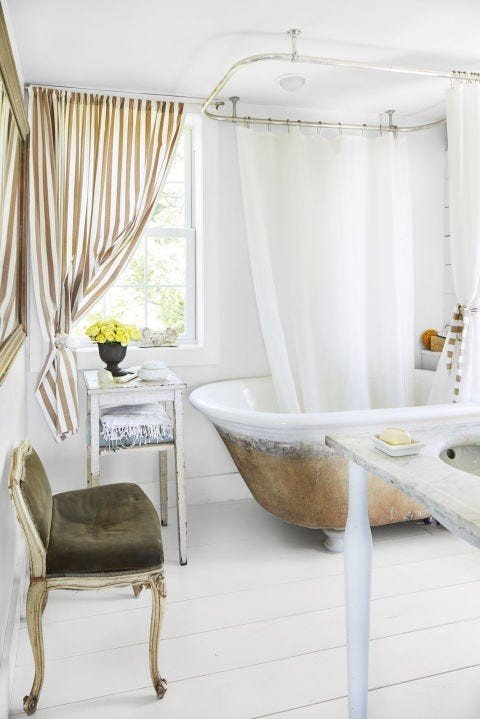 Luxury white bathroom design ideas featuring hammered copper clawfoot tub, white shiplap, and pendant illumination
