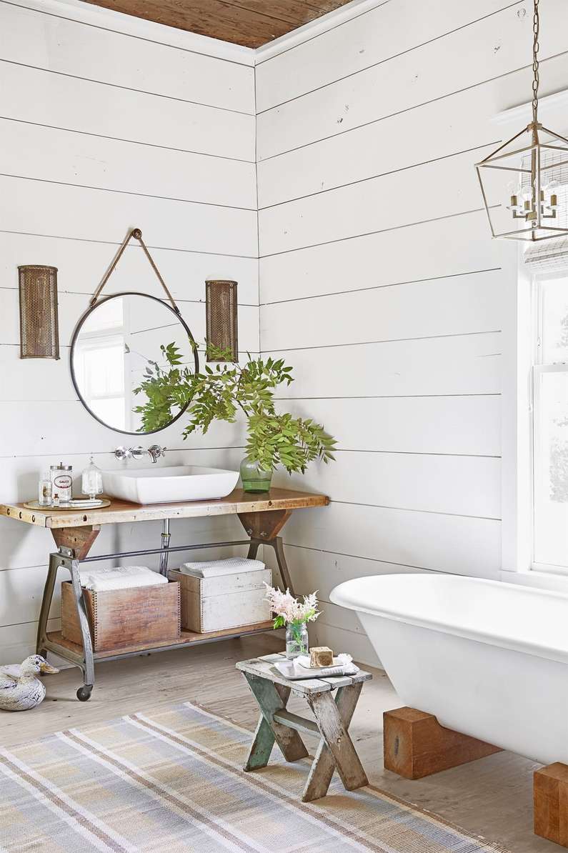 Coastal white bathroom design ideas featuring white shiplap walls contrasting with a rich natural wood vanity.