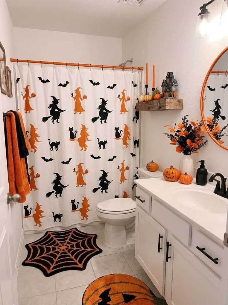 White bathroom, black witch cat shower curtain, spiderweb rug, soft gray tiles, cool white LED lighting.