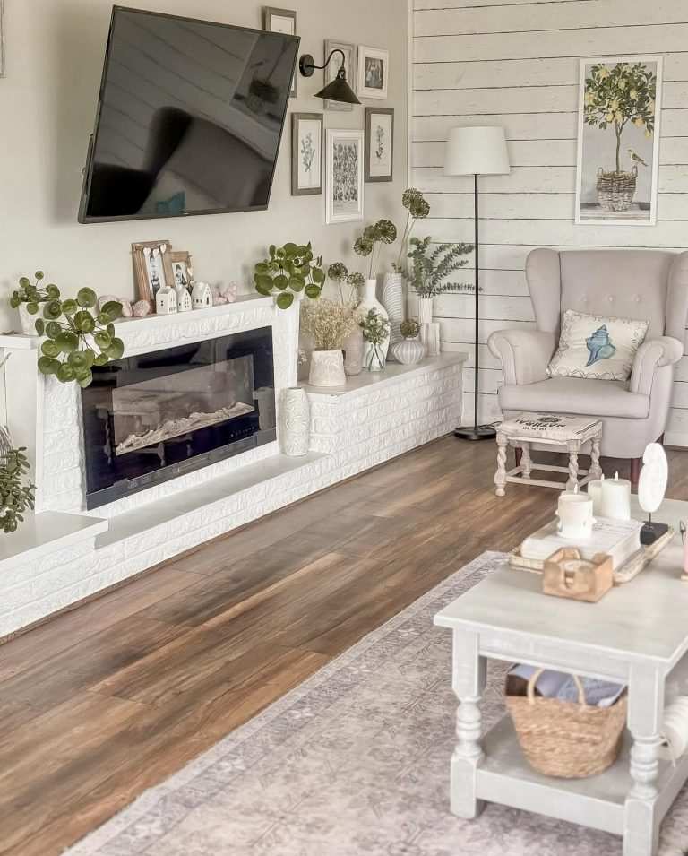 Living room with white brick fireplace, light sofa, soft lighting, minimalist décor.