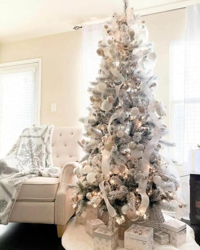 Scandinavian sitting room showcasing white ribbon christmas tree by fireplace in gentle daylight