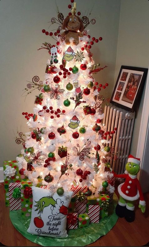 White flocked tree with a Max dog topper in a cozy room