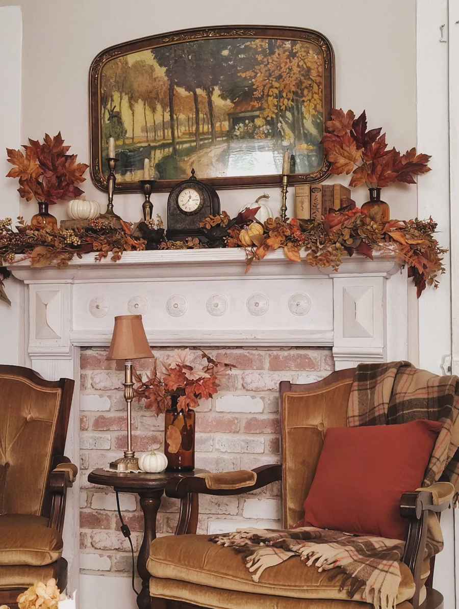 Hallway wall, white mantel, large abstract autumn painting, dried leaf garland, recessed LED lighting.