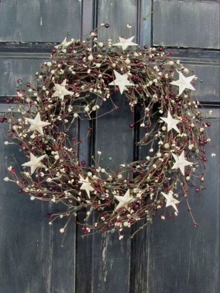 A minimalist wreath featuring white star ornaments on a simple greenery base.