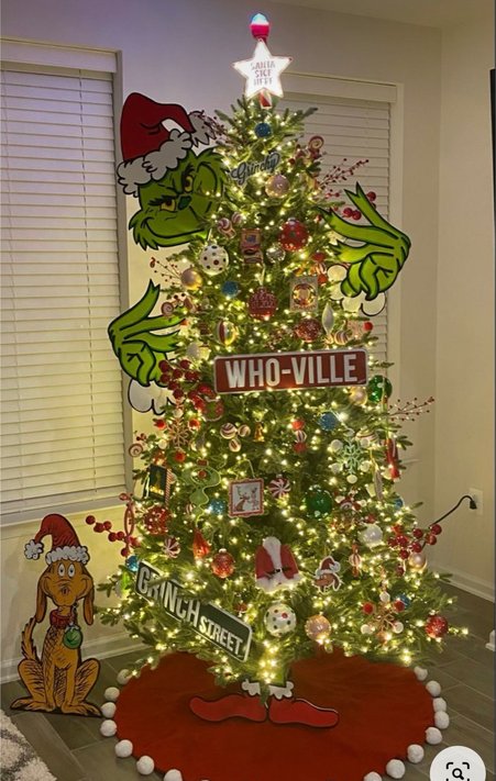 Tree with circular Who-ville style signs and green foliage in a bright space
