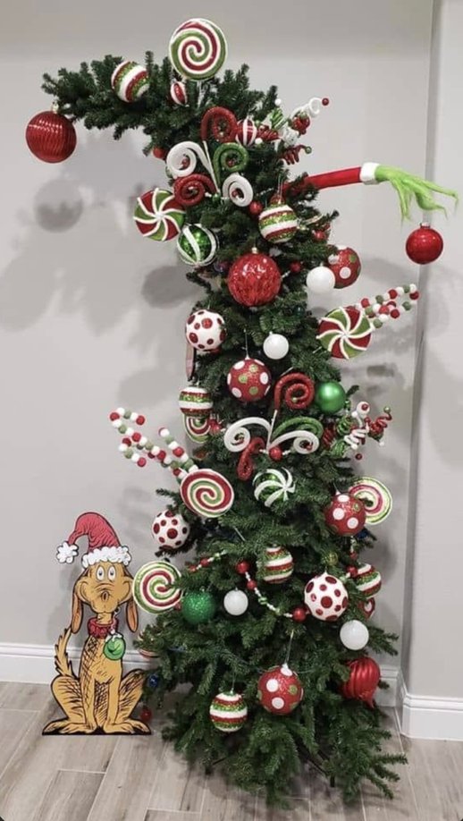 Tree with a Max dog figure and peppermint ornaments in a bright room