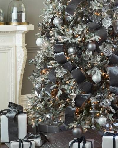 Modern great room highlighting wide ribbon christmas tree near tailored sectional under high ceiling lighting