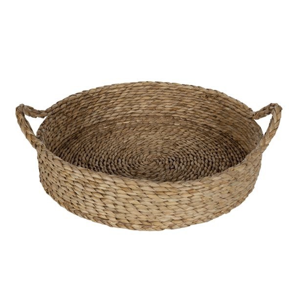 A large woven basket filled with cozy throw blankets in a living room