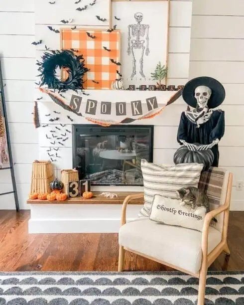 Skeleton wearing a witch hat and glasses on a fireplace mantel.