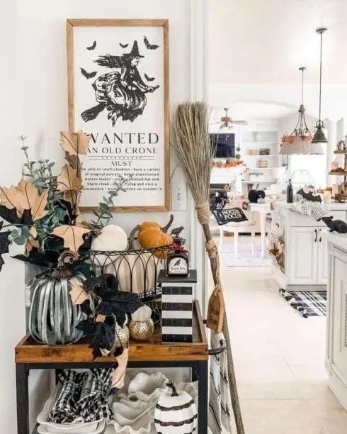 Rolling cart with a witch sign, cinnamon broom, and spice jars.