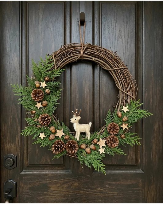 Woodland grapevine deer wreath on white wall with natural light