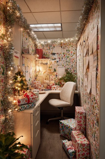 A desk covered in a layer of festive wrapping paper.