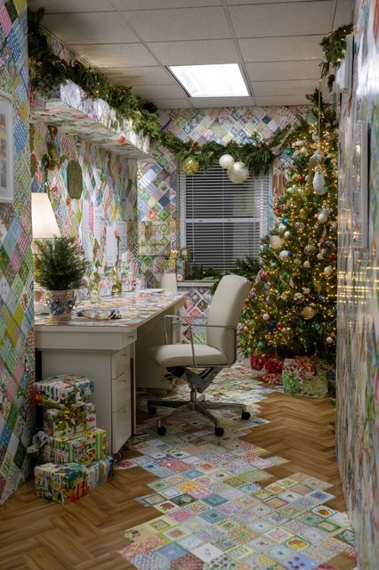 A section of wall covered in festive wrapping paper with a subtle geometric pattern.
